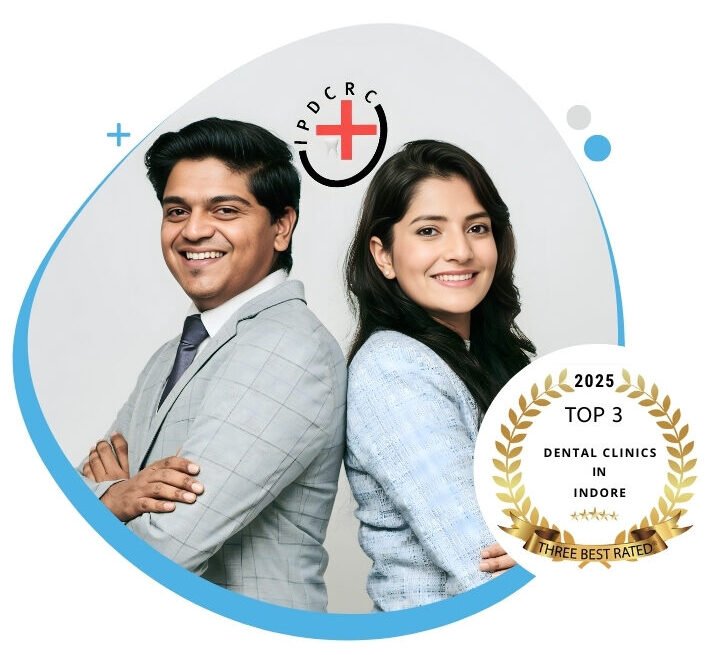 Two professional dentists standing back to back, representing a top-rated dental clinic in Indore with a 2025 Top 3 dental clinics award badge.