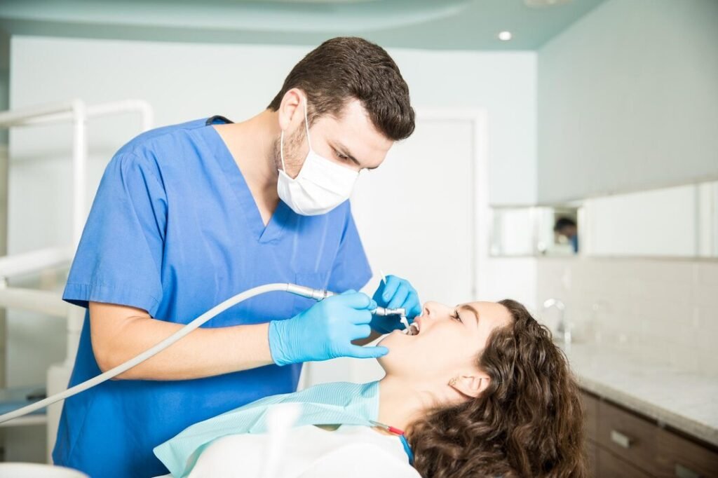 Dentist performing dental treatment using modern equipment in a dental clinic