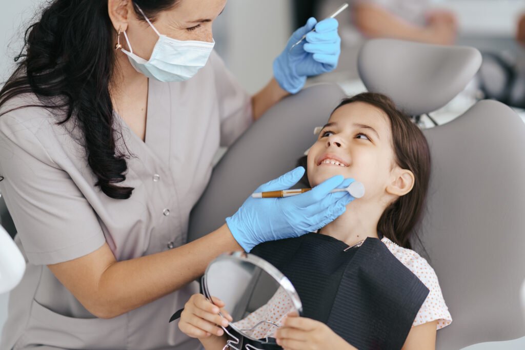 Child receiving gentle dental checkup from pediatric dentist in clinic